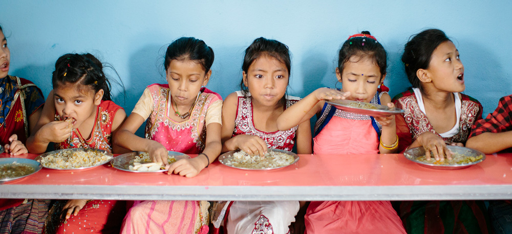Girls at the contact center in Kathmandu enjoy some lunch.